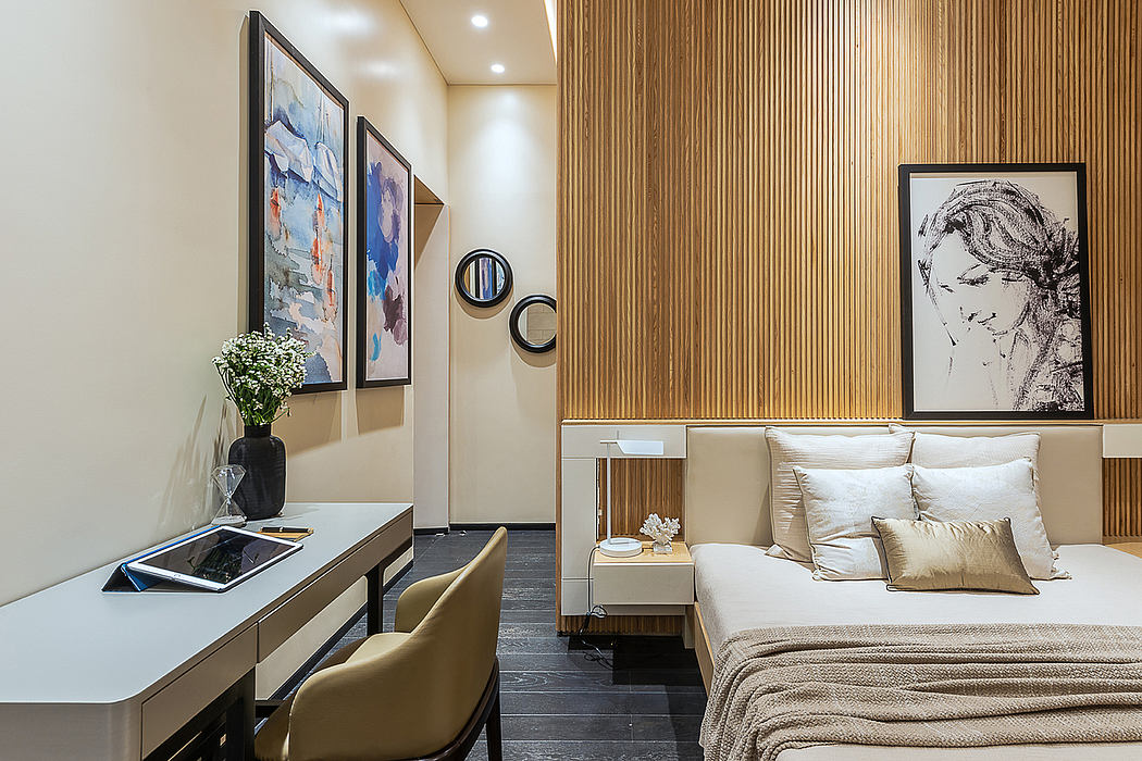 Elegant bedroom interior with wooden paneling, framed artwork, and a comfortable bed.