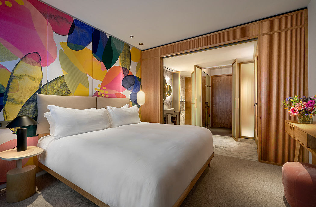 Vibrant, abstract wall mural adds bold visual interest to the modern, wood-paneled bedroom.