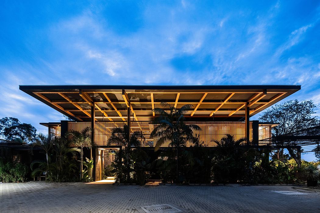 Striking wooden structure with a large overhanging roof and tropical landscaping.