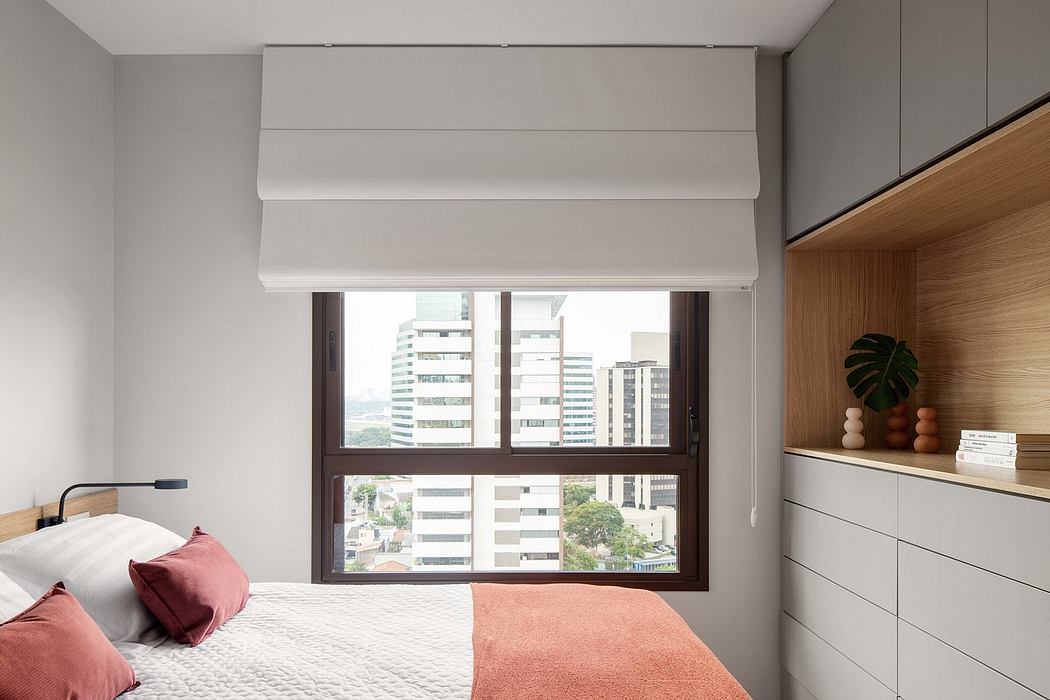 Minimalist bedroom interior with sleek window, built-in shelving, and warm decor accents.