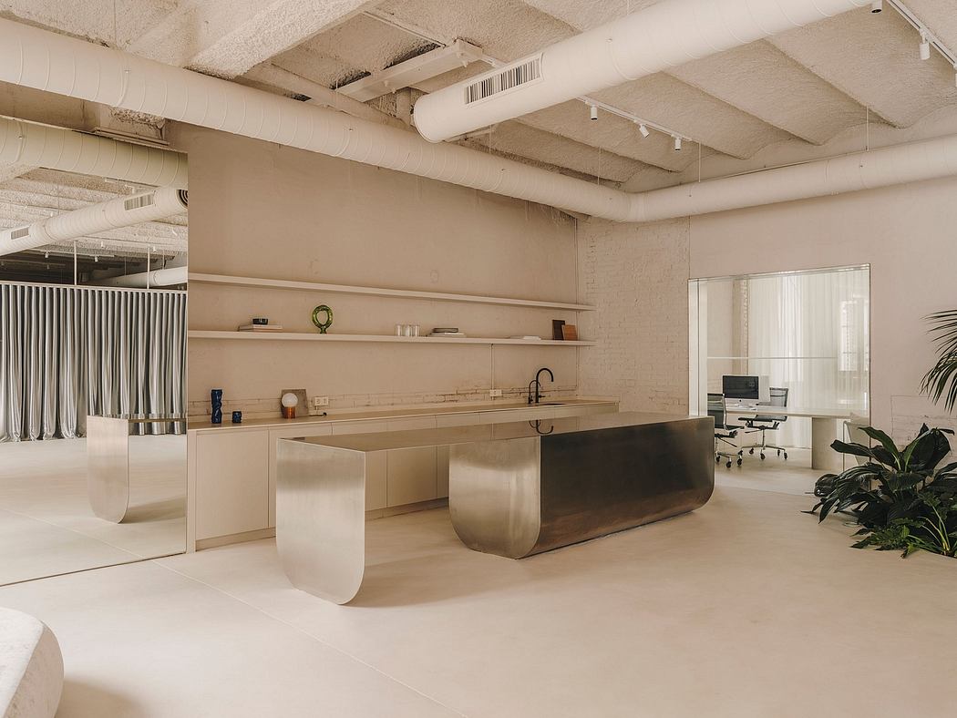 Minimalist open-concept office with modern curved furniture and industrial ceiling.