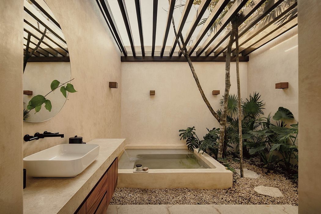 A modern bathroom with a recessed bathtub, surrounded by tropical foliage and a wooden ceiling.