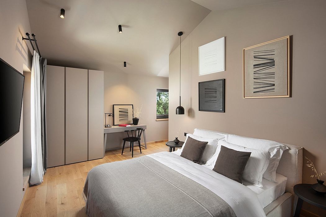 Minimalist bedroom with grey built-in cabinetry, wooden floor, and abstract wall art.