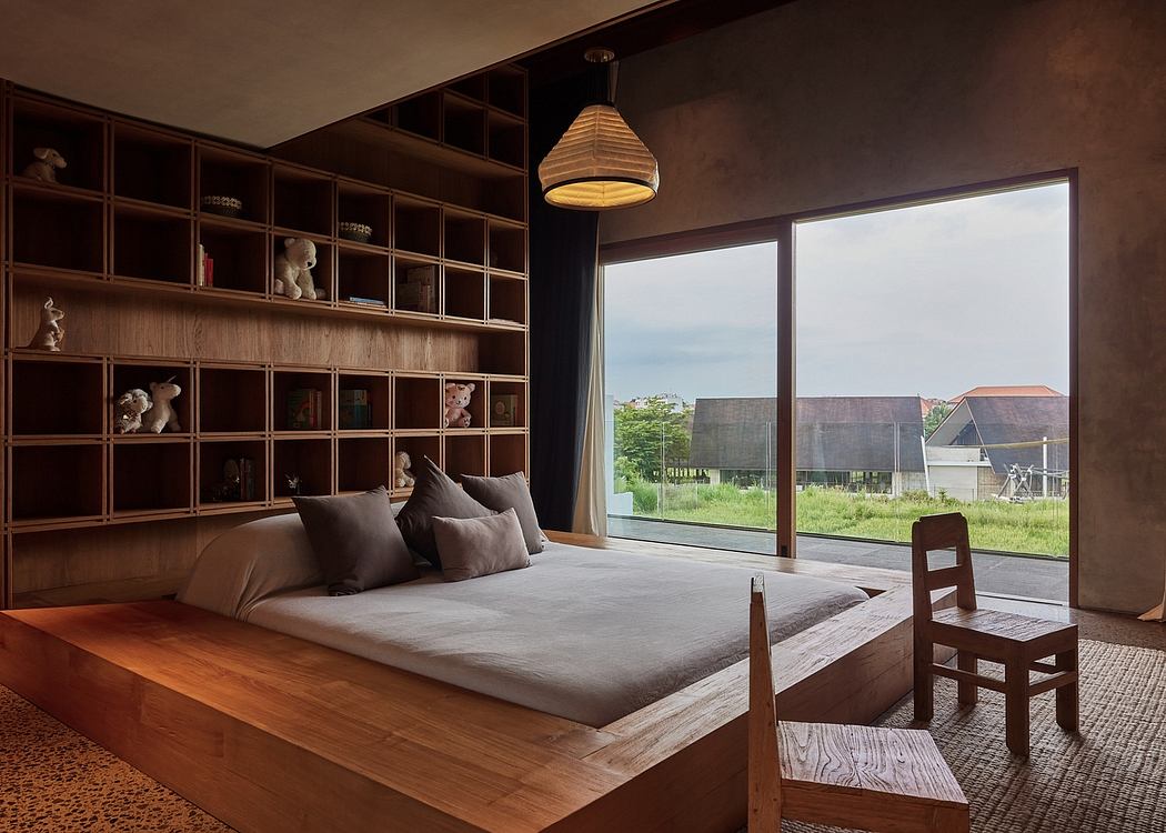 A cozy bedroom with an expansive view, wooden shelves, and a hanging light fixture.