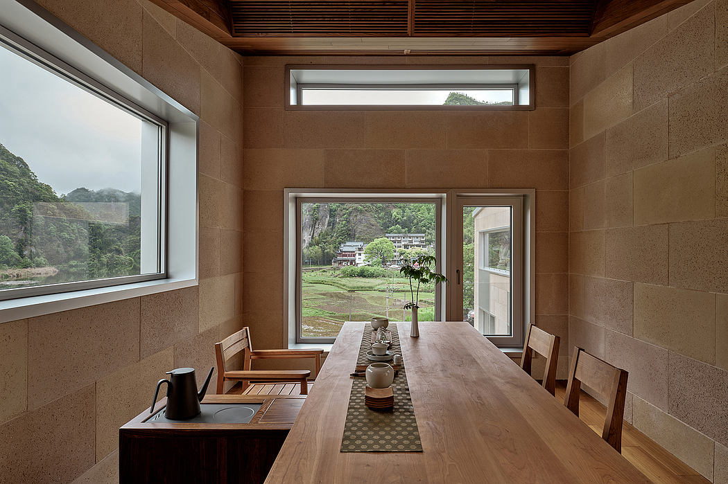 A spacious and rustic dining area with floor-to-ceiling windows offering scenic mountain views.