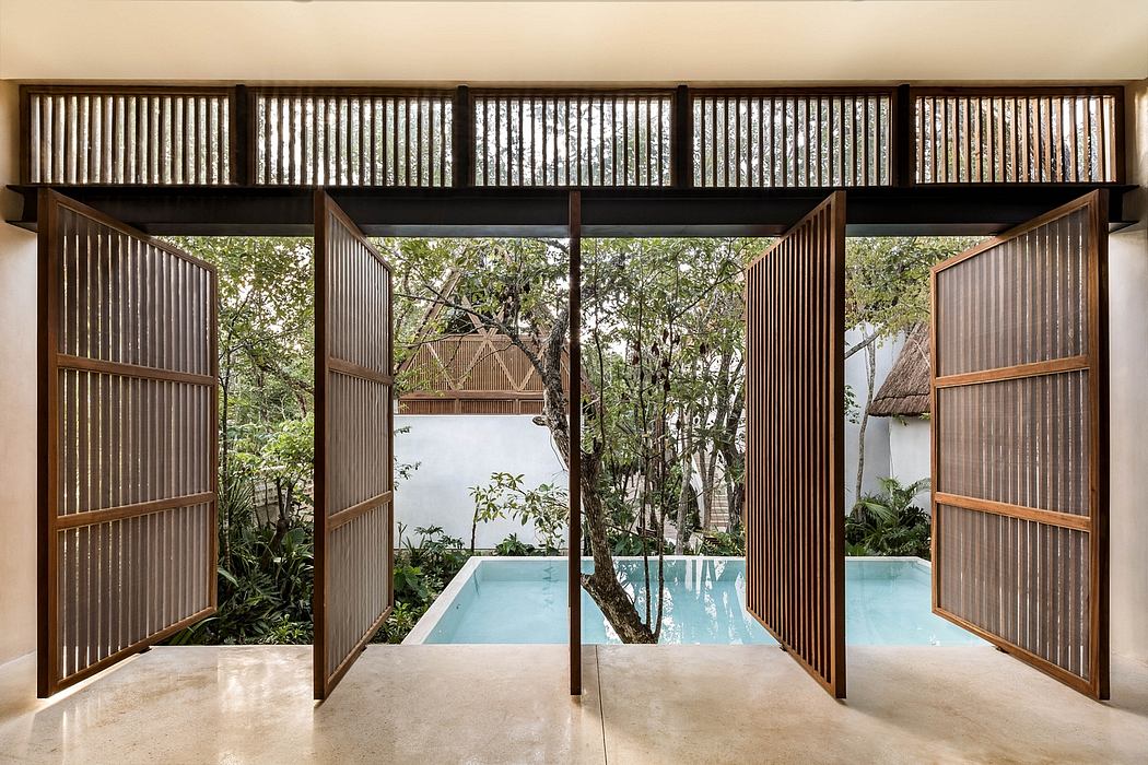 Stunning wooden architecture with slatted screens framing lush garden and pool.