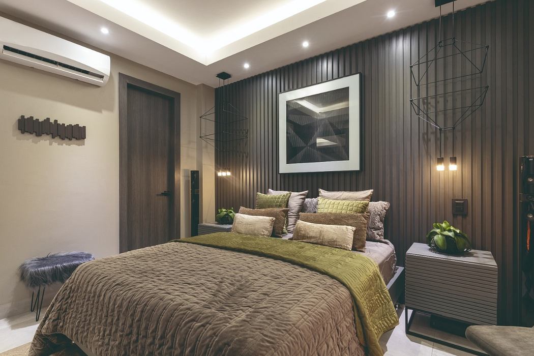 A modern bedroom with textured wall paneling, recessed lighting, and a large artwork.