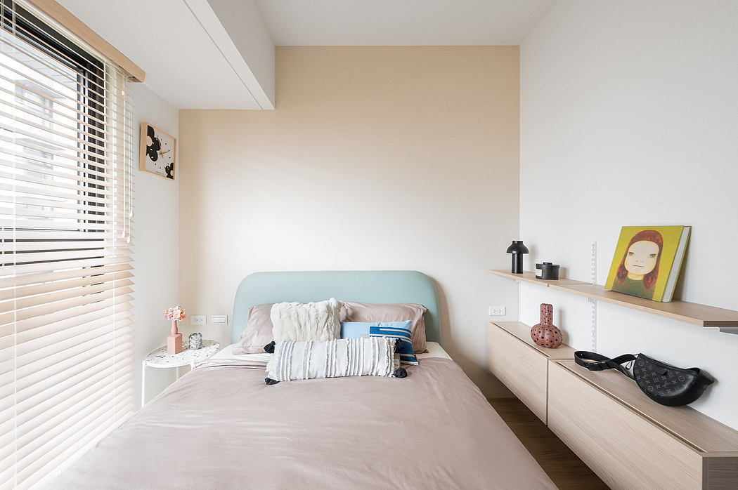 A cozy, minimalist bedroom with a pastel green headboard, shelves, and tasteful decor.
