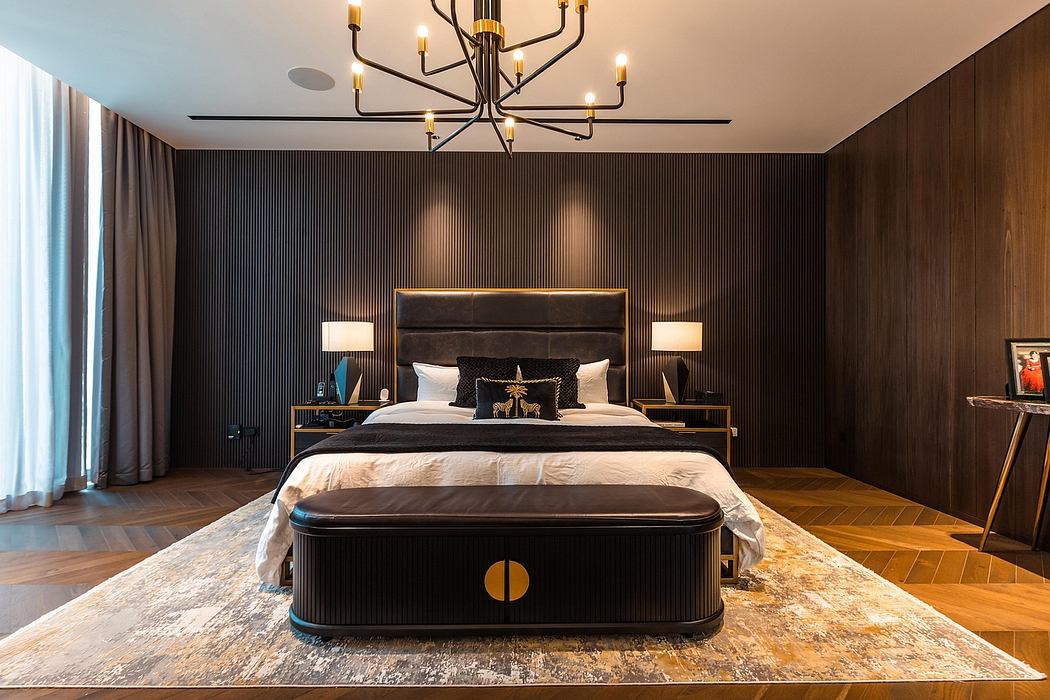 Luxurious bedroom with a striking chandelier, dark wood paneling, and a grand bed frame.