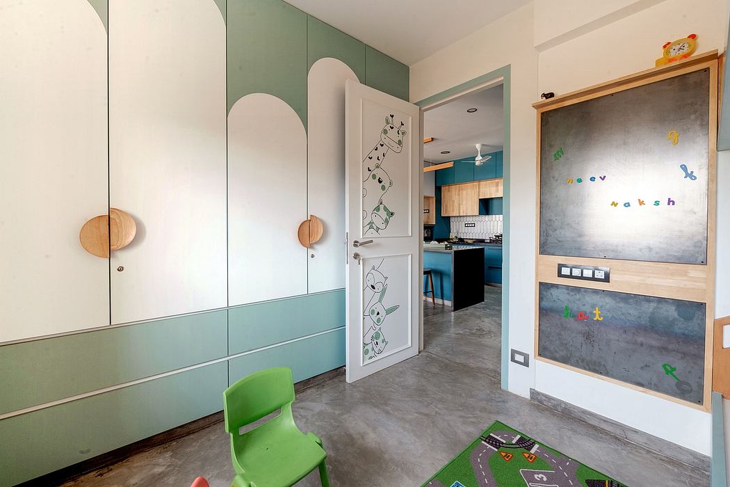 Modern, vibrant room with pastel cabinets, playful chalkboard, and integrated kitchen.