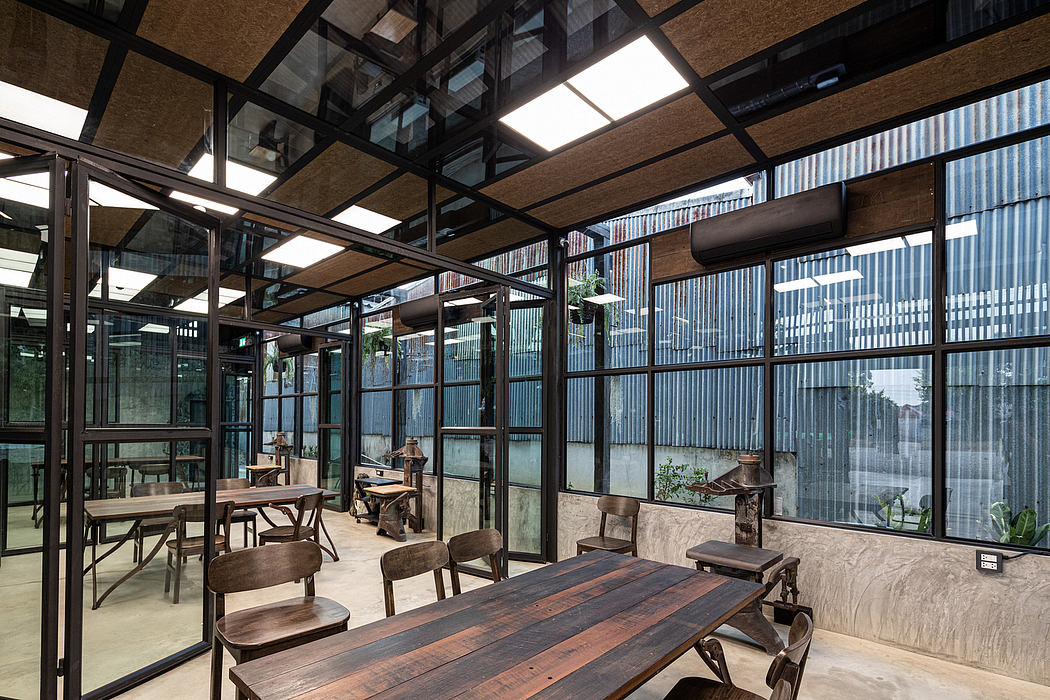 Rustic, industrial-style cafe with wooden furnishings, large glass windows, and natural light.