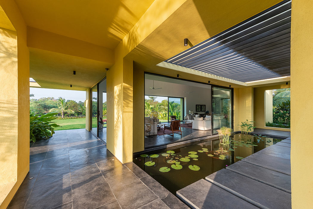 Spacious open-concept interior with sleek architectural features and lush tropical views.