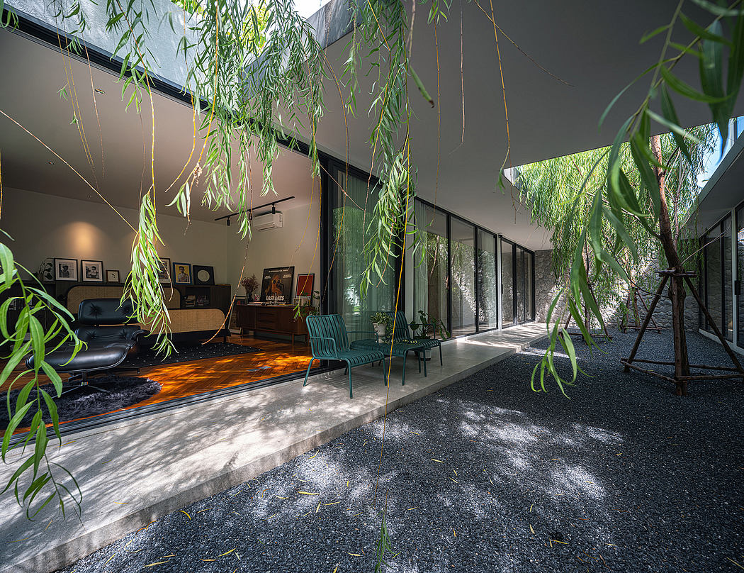 A modern, open-plan living space surrounded by lush, overhanging foliage and natural materials.