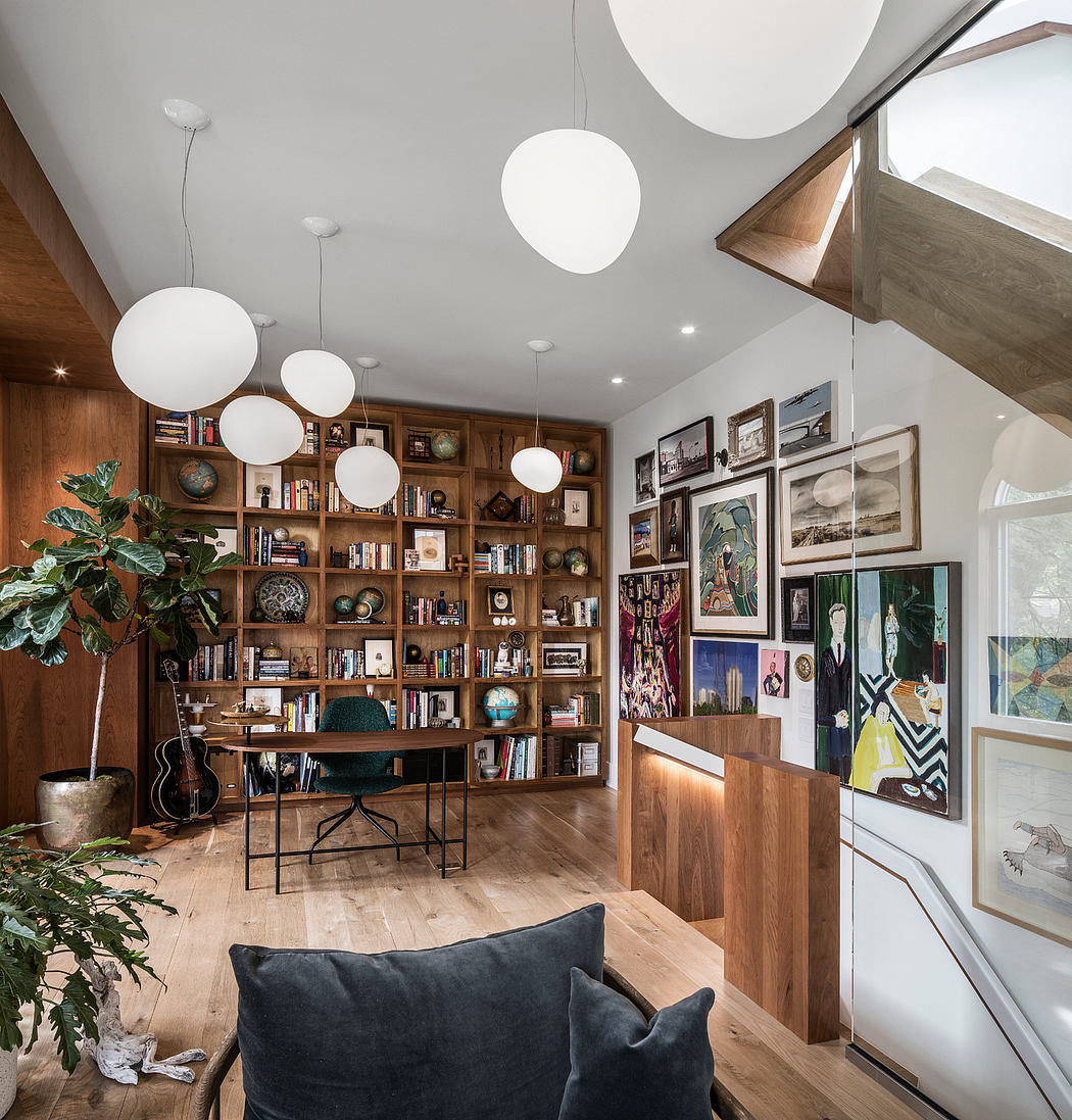 Cozy home office with built-in wooden bookshelves, modern lighting, and eclectic decor.