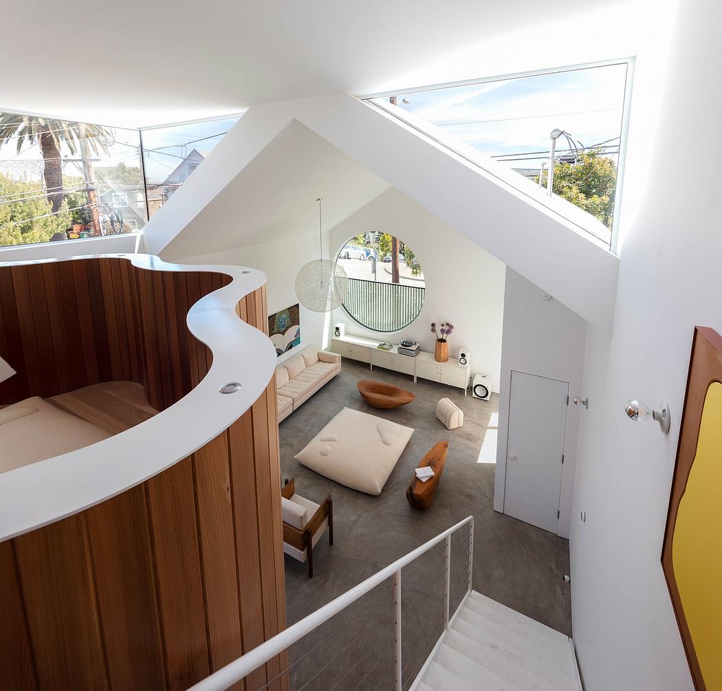 A modern, open-concept living space with curved wooden accents and natural lighting.