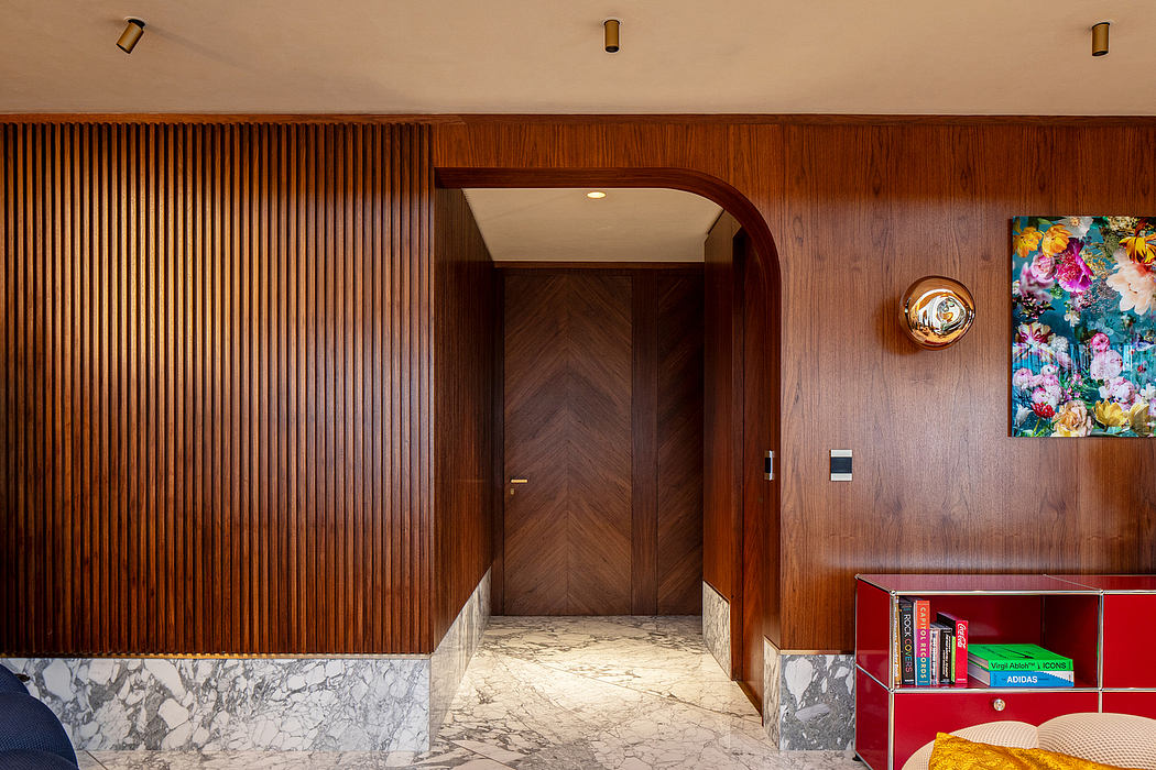 Warm-toned wood paneling, marble accents, and decorative lighting create a stylish interior.