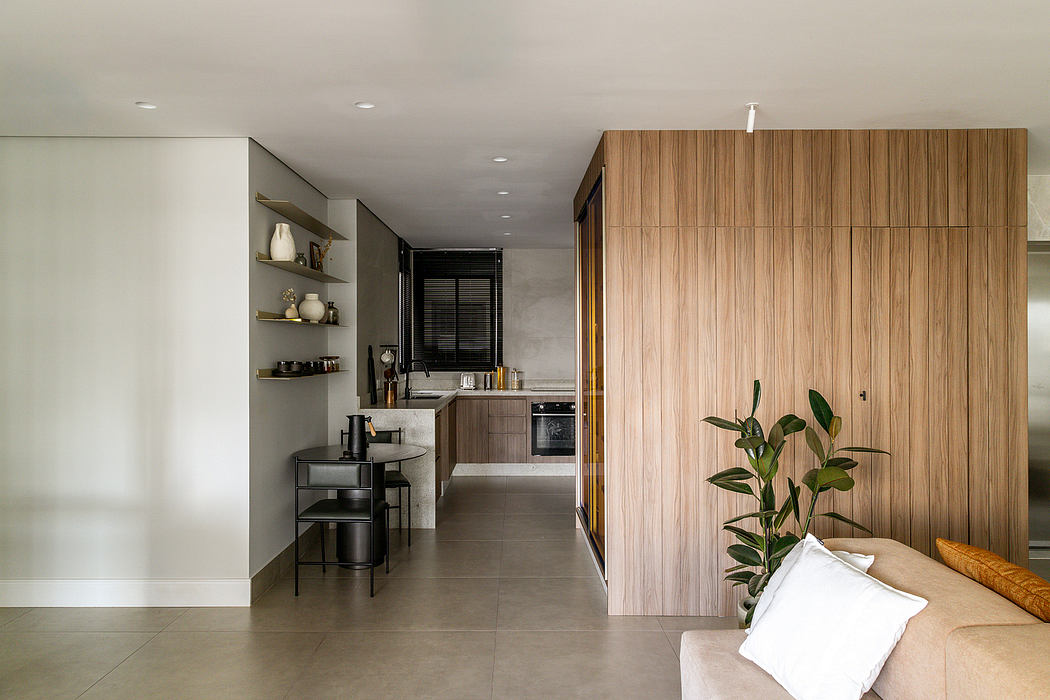 Sleek modern kitchenette with wood paneling, open shelving, and minimalist decor.