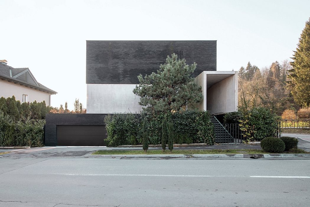 Sleek, modern home with contrasting materials, bold architectural features, and lush landscaping.