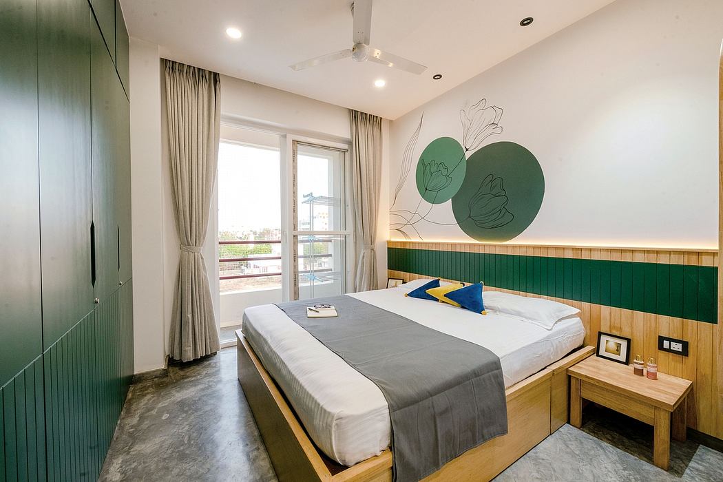 Cozy modern bedroom with geometric wall art, wooden accents, and large windows.