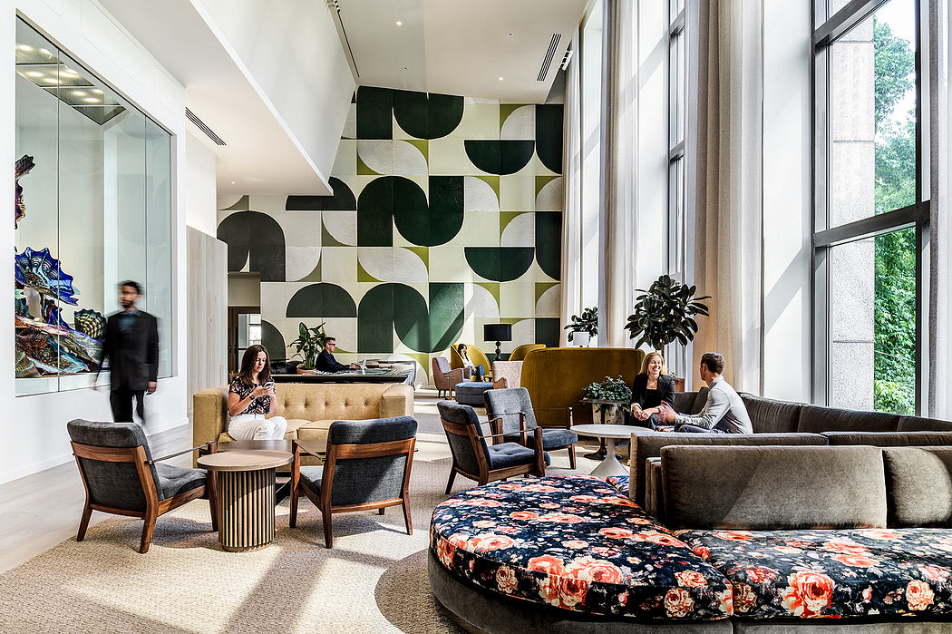 Spacious modern lobby with bold abstract wall art, plush seating, and large windows.