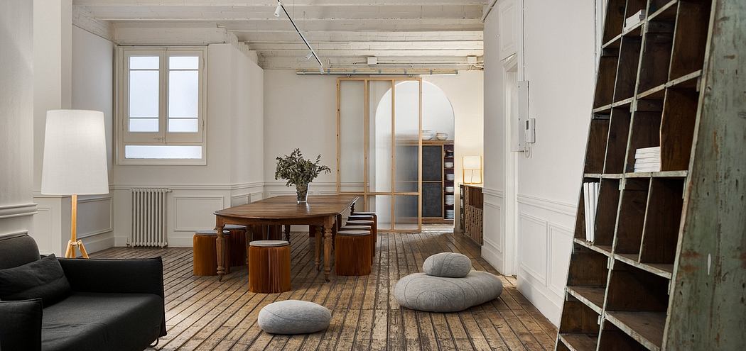 Spacious room with wooden floors, arched doorway, and modern wooden furniture.