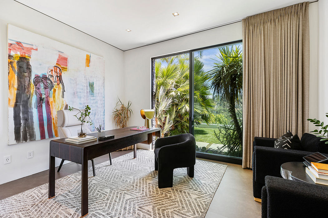 Minimalist home office with abstract art, tropical landscape view, patterned rug.