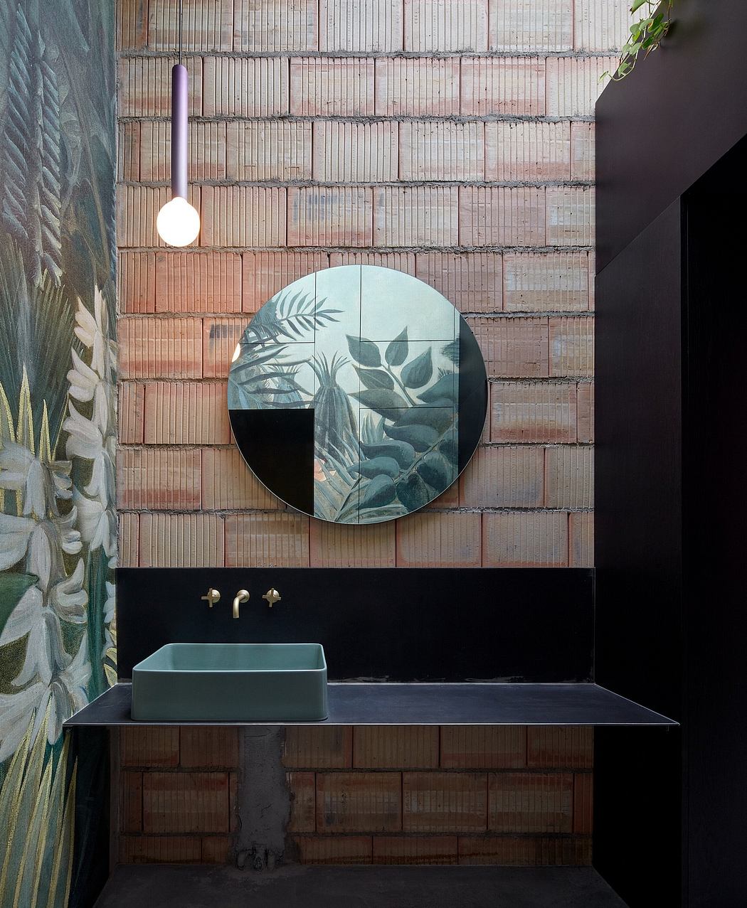 Minimalist bathroom design with round mirror, artwork, and contemporary fixtures.