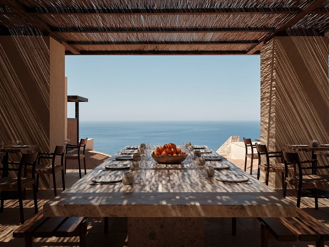 An outdoor dining area with rustic wooden furnishings, set against a breathtaking ocean view.