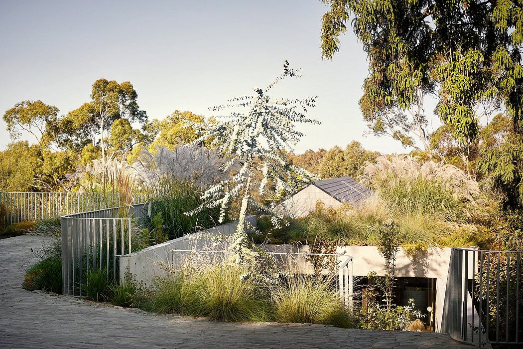 A modern, minimalist outdoor garden design with a striking architectural structure.