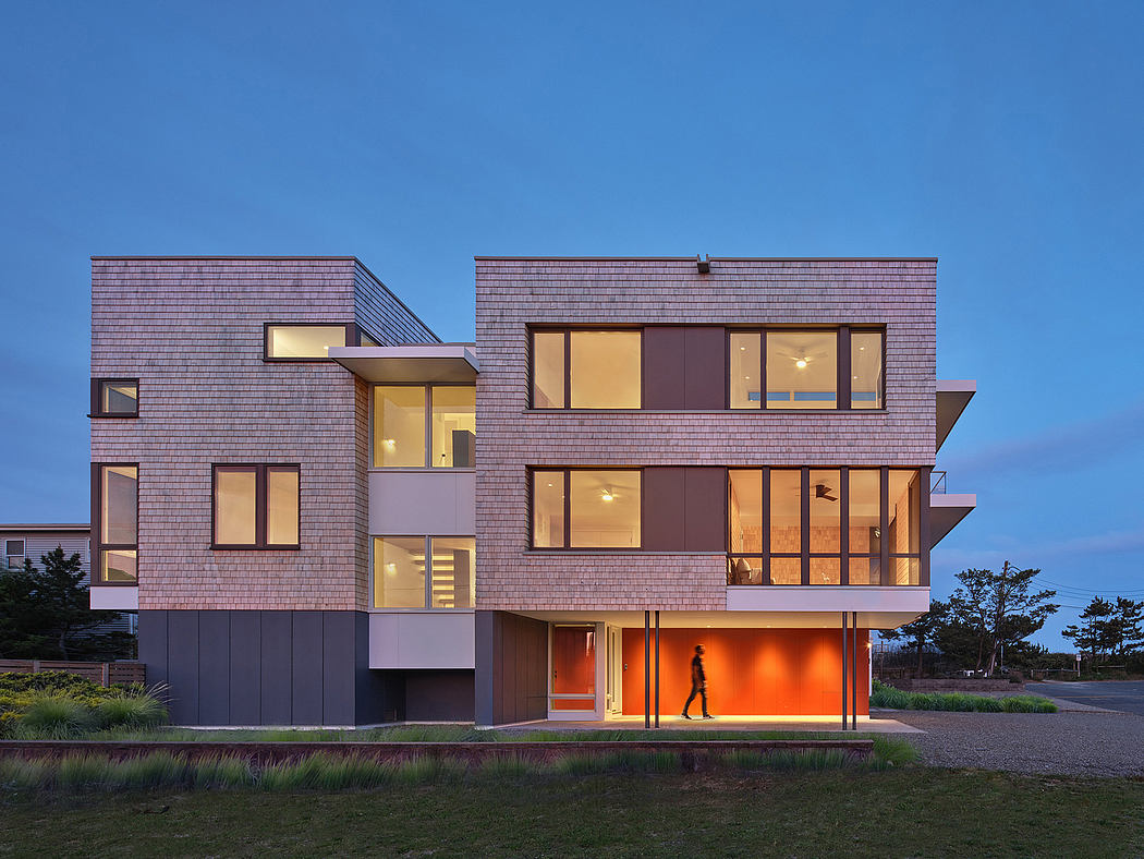 Modernist residential building with distinctive purple shingle facade, expansive glazing.