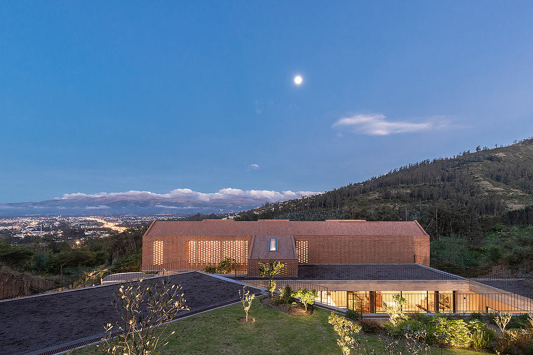 Sprawling modern hillside residence with brick exterior and expansive decks.