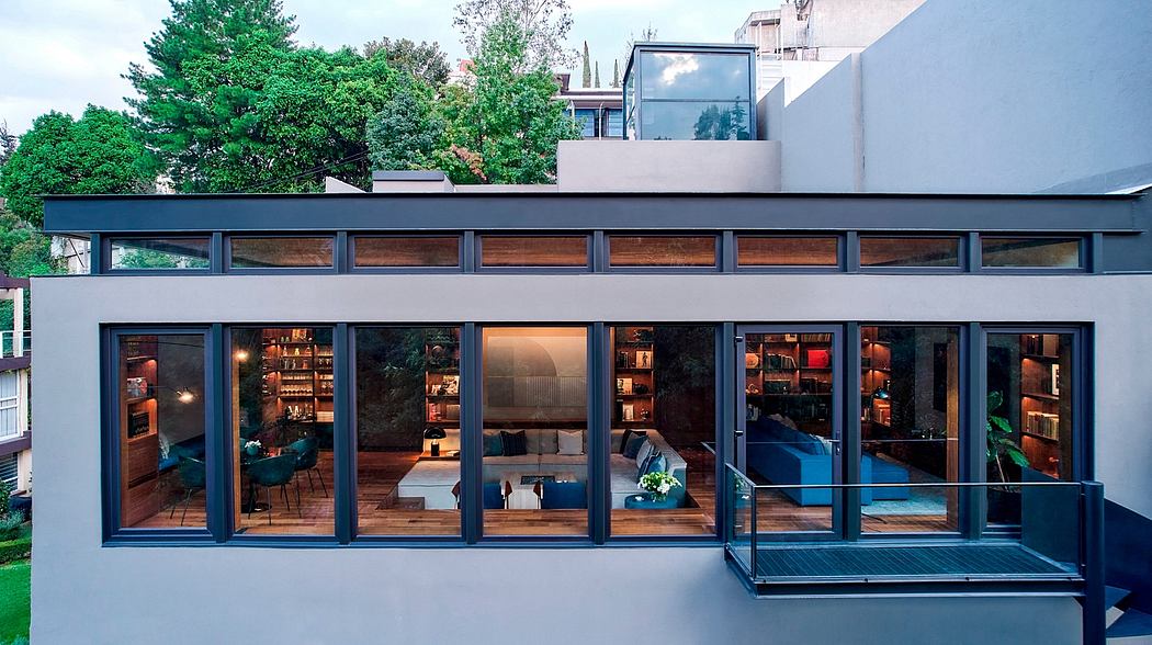 Modern glass-walled building with wooden accents, indoor-outdoor living space.