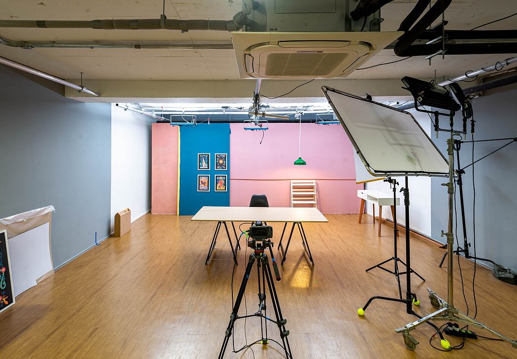 A colorful, well-equipped studio with vibrant walls, professional lighting, and a camera on a tripod.