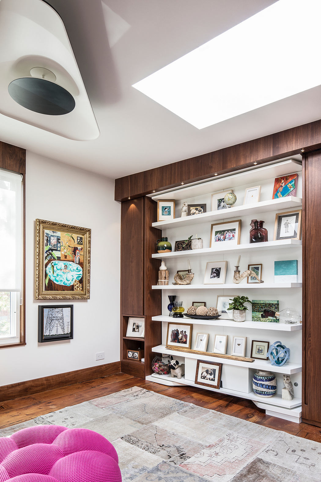 A cozy, well-designed living room featuring a modern wall unit and eclectic decor.