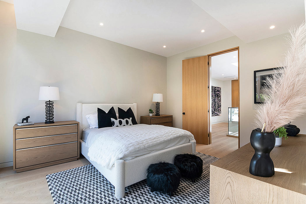 Minimalist bedroom with light wood furniture, plush textures, and geometric patterns.