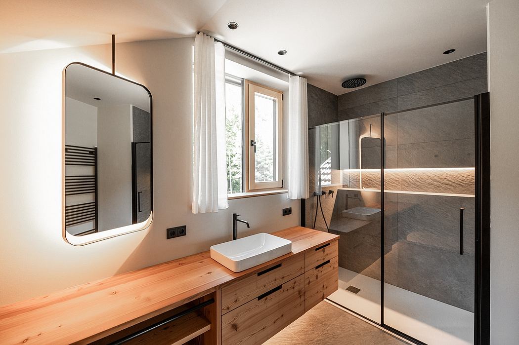 Modern bathroom with wooden vanity, vessel sink, and glass shower enclosure.