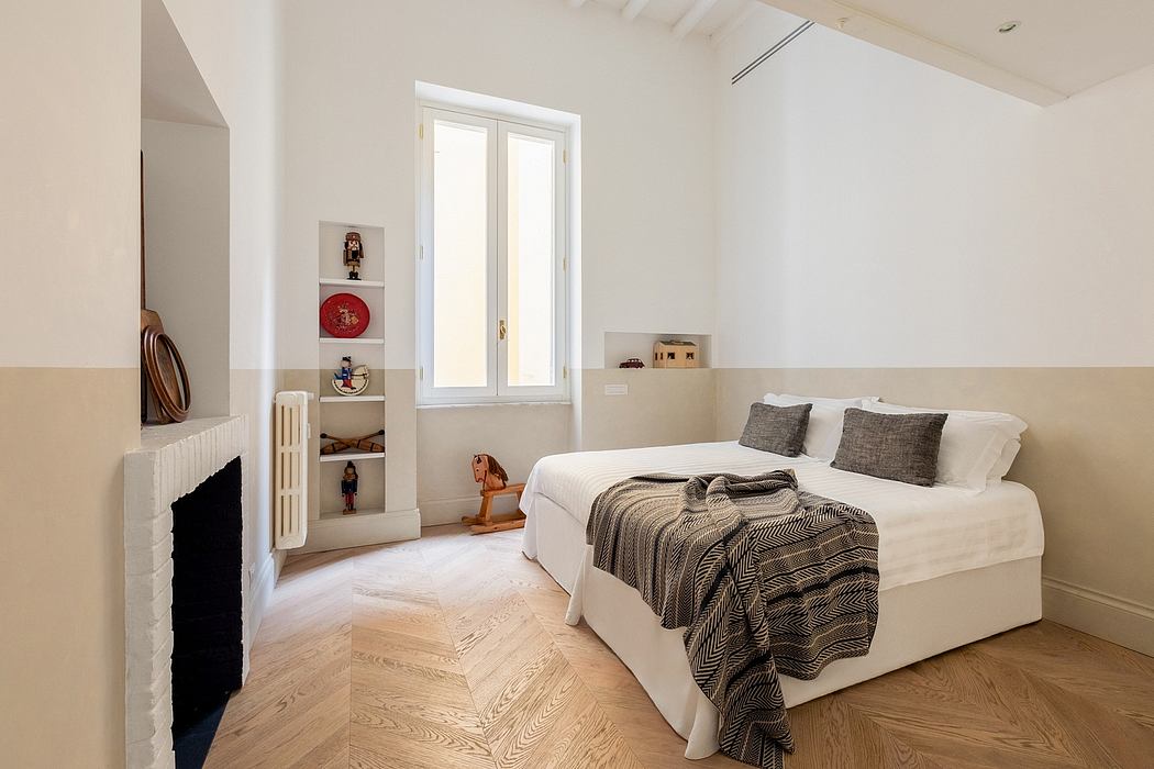 Cozy bedroom with white walls, hardwood floors, and a built-in shelf for decor.