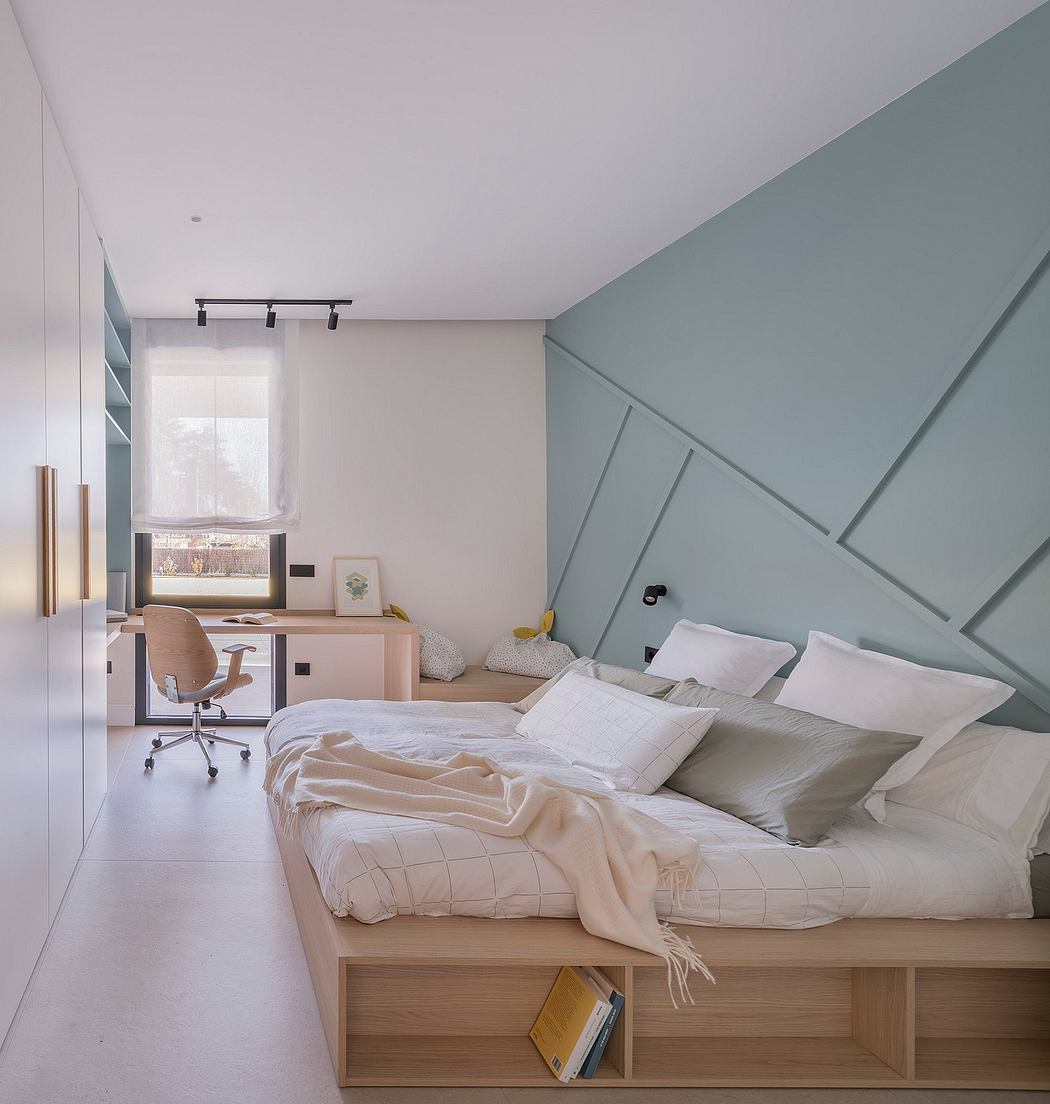 Minimalist bedroom design with geometric wall paneling and built-in desk nook.