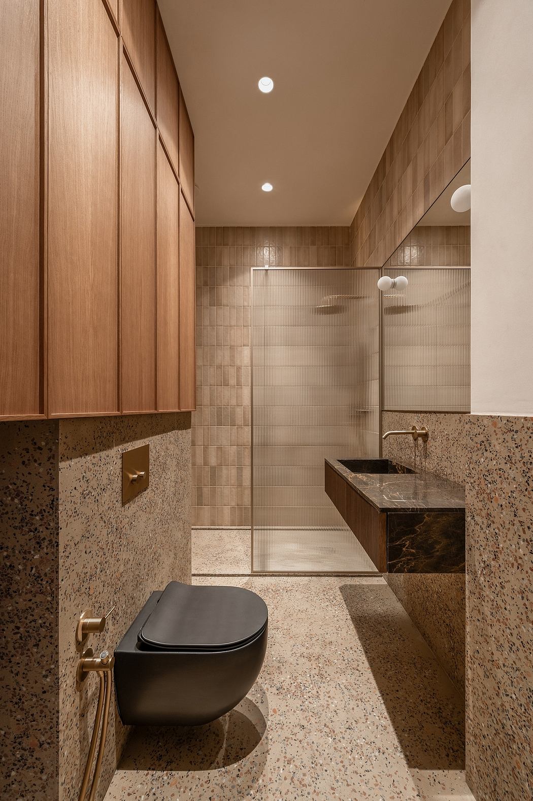 A modern bathroom with wooden paneling, marble vanity, and sleek toilet design.