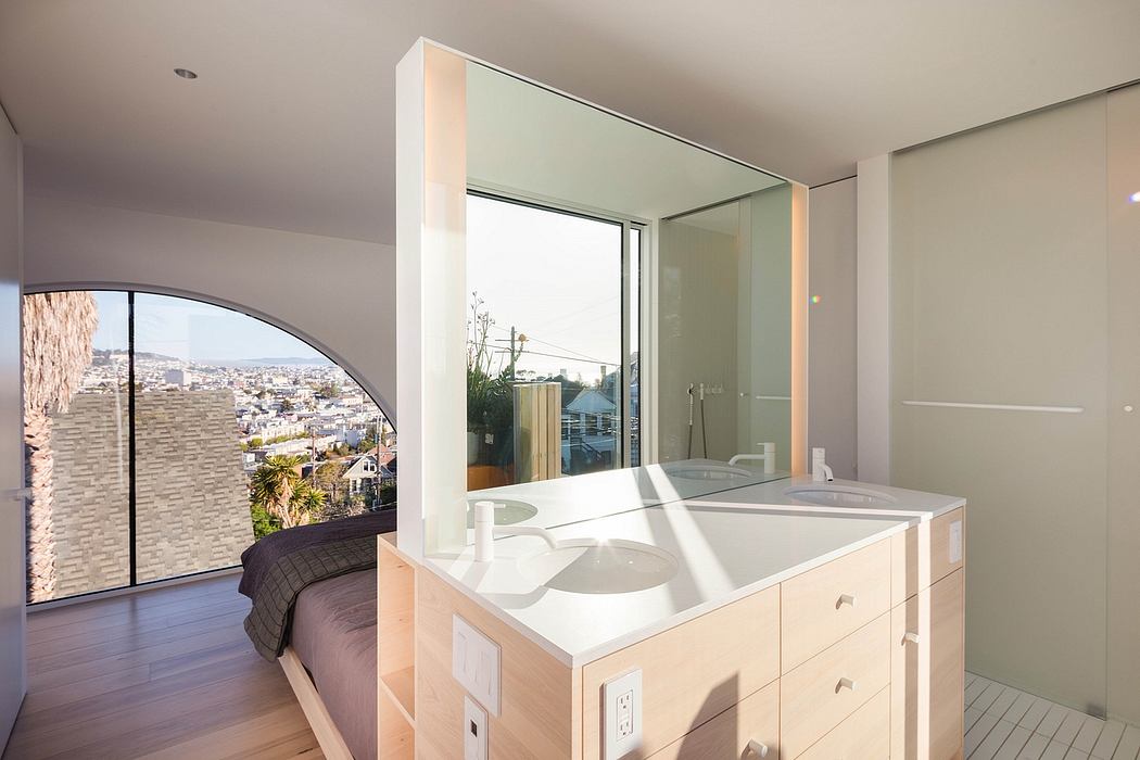 Modern bathroom with sleek vanity and large window overlooking city skyline.