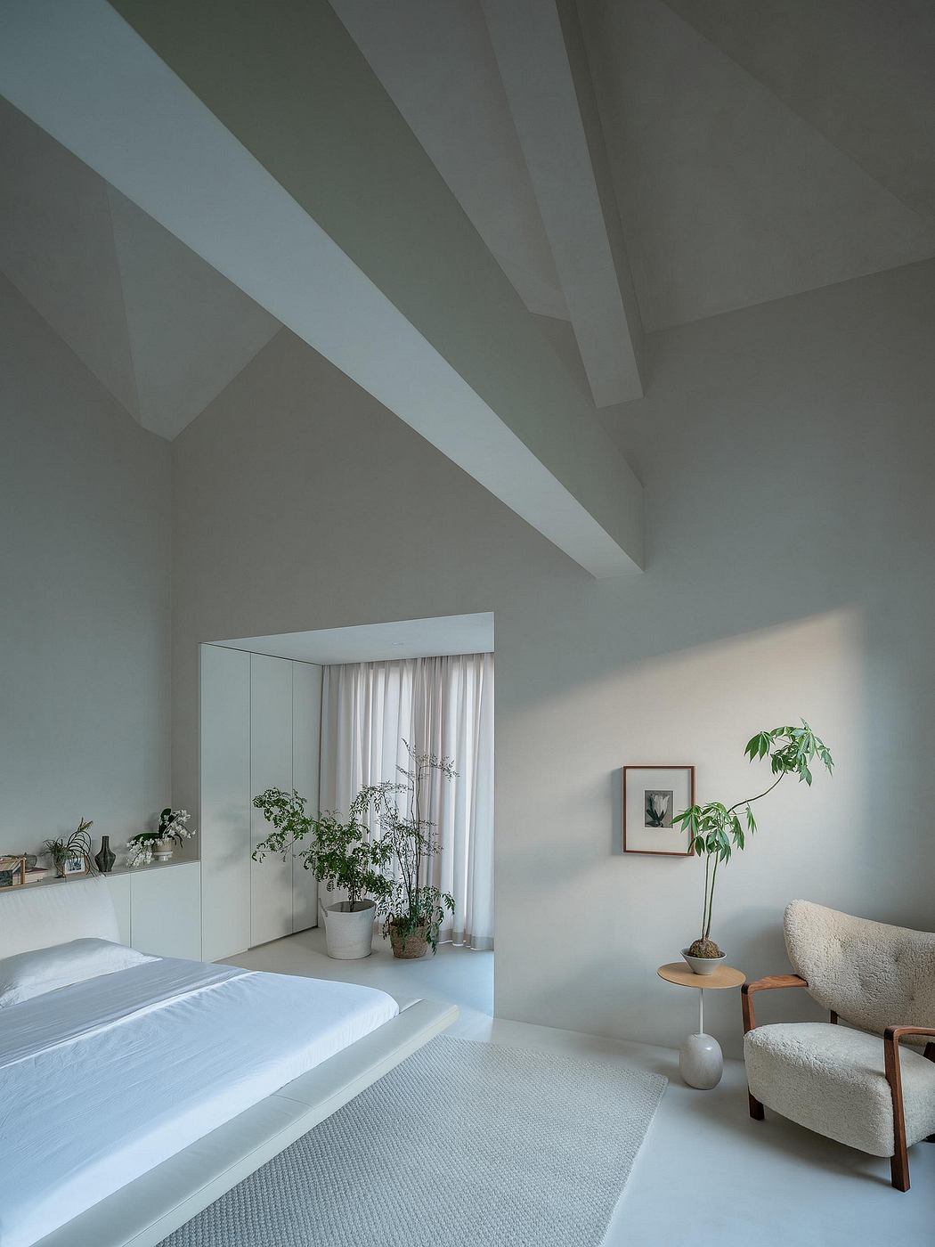A serene bedroom with a modern, minimalist aesthetic and natural elements.
