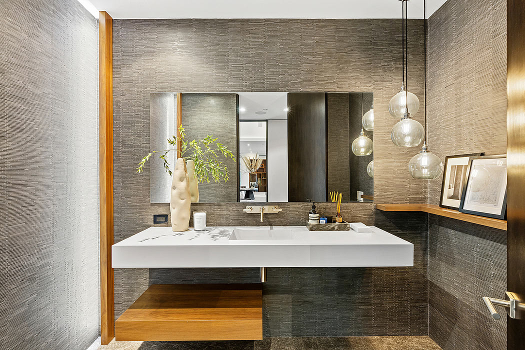 Sleek modern bathroom with textured gray walls, floating vanity, and suspended lighting.