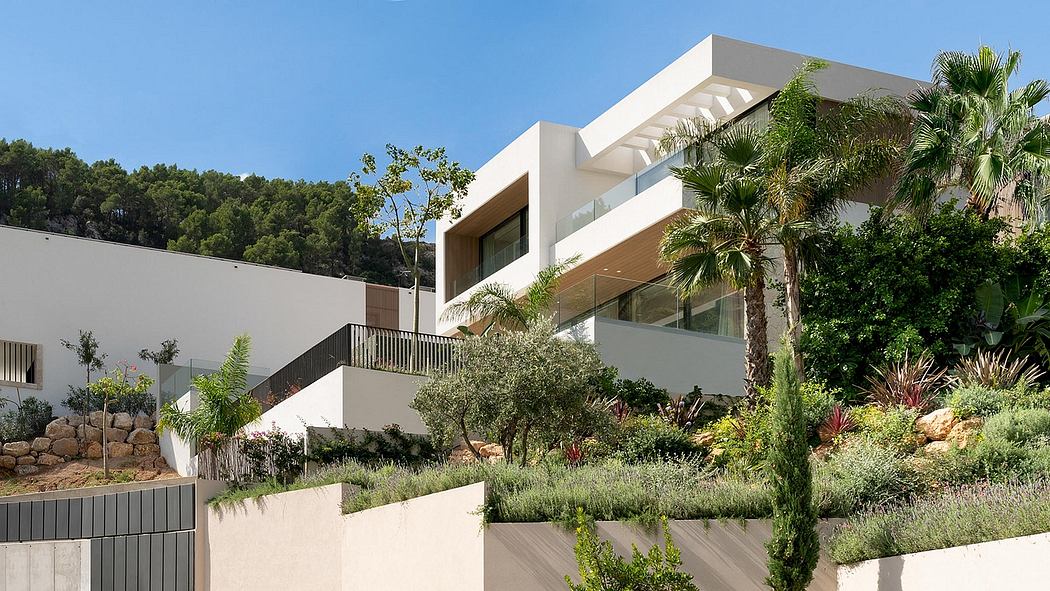 Modern, multi-level residence featuring clean lines, large windows, and lush landscaping.