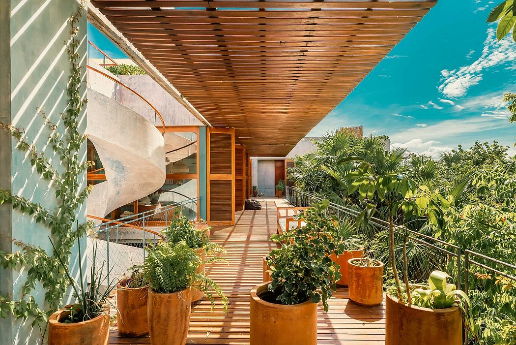A wooden slatted canopy shelters a lush, tropical patio with potted plants.