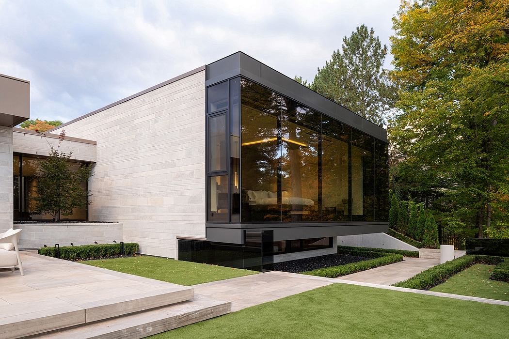 Sleek, modern architecture with glass facade, minimalist landscaping, and inviting outdoor space.