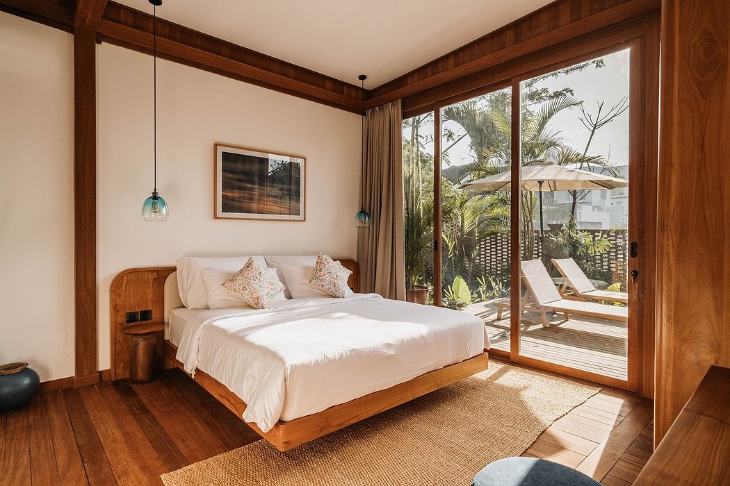 Cozy, wood-paneled bedroom with large sliding glass doors overlooking lush vegetation.