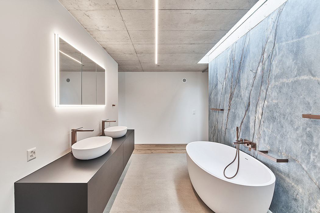 Spacious bathroom with modern fixtures, minimalist design, and striking blue marble wall.