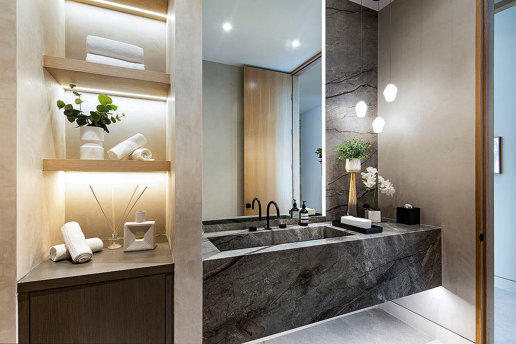 Modern bathroom with sleek marble vanity, recessed lighting, and lush greenery accents.