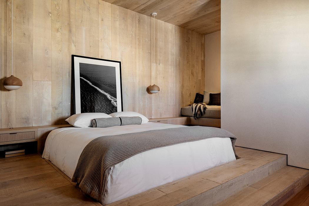 Rustic wooden bedroom with minimalist decor and framed artwork on the wall.