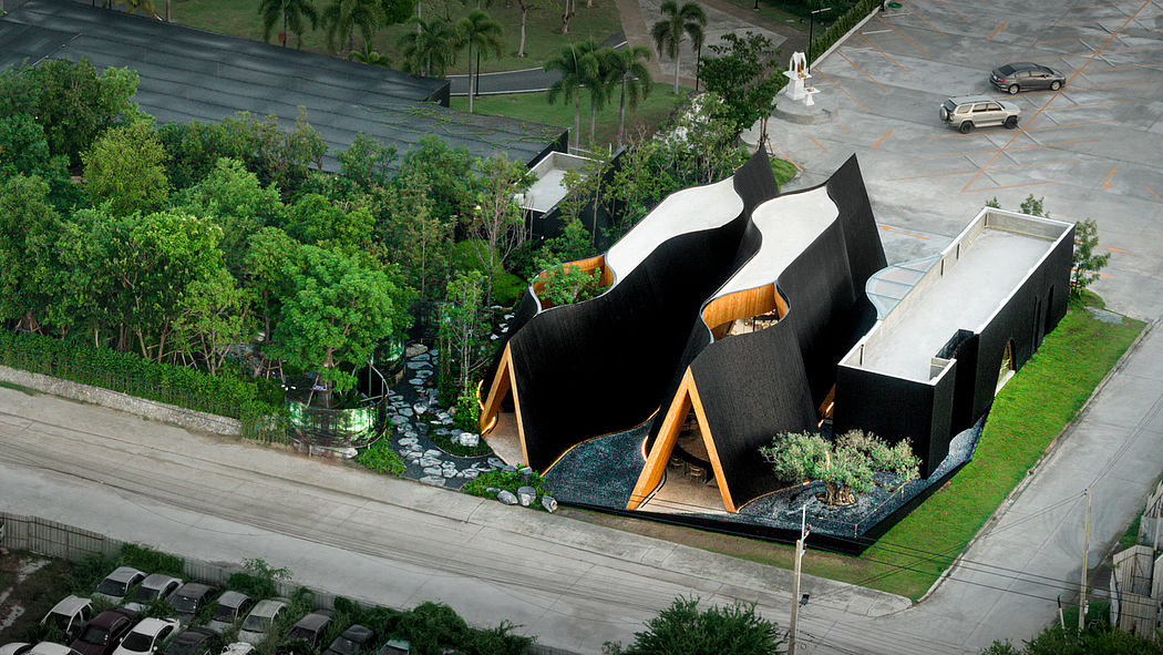 Striking modern architectural structure with unique angular shapes and natural elements.